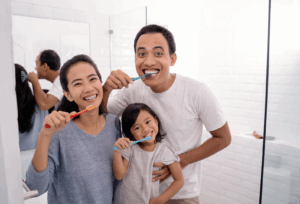 Family brushing their teeth together