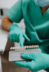 Dentist showing veneers' samples to patient
