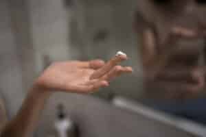 Woman using tooth mousse